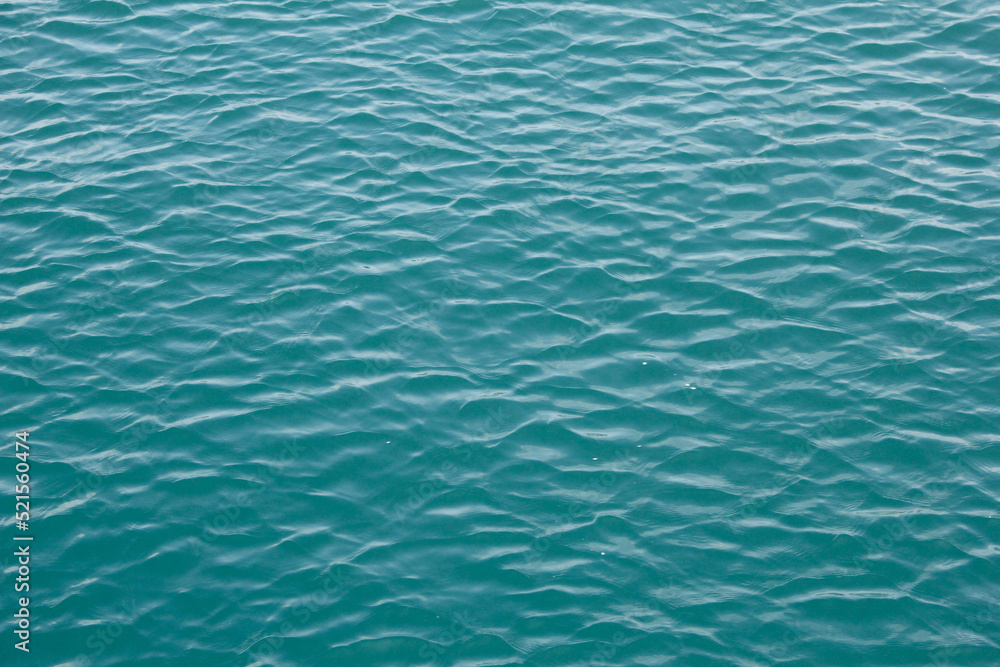 A view of calm ocean water texture, as a background. A view of calm ocean water texture, as a background.
