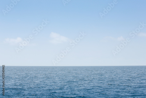 A view of a simple ocean landscape with a blue sky.