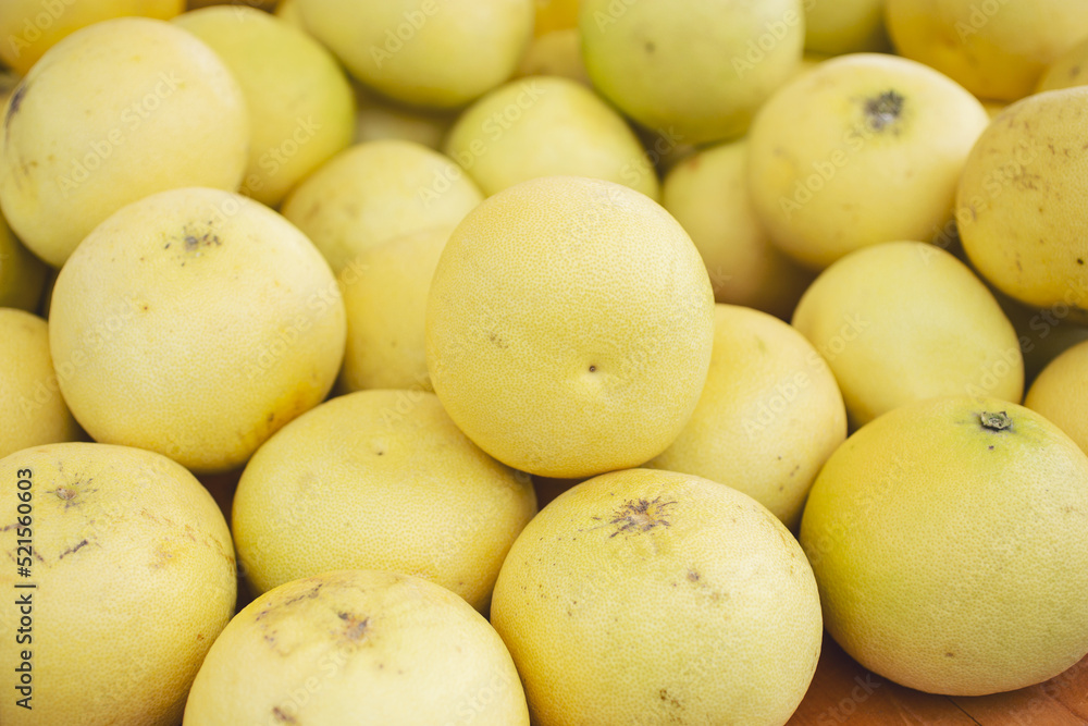 A view of a pile of grapefruit, on display at a local farmers market. A view of a pile of grapefruit, on display at a local farmers market.