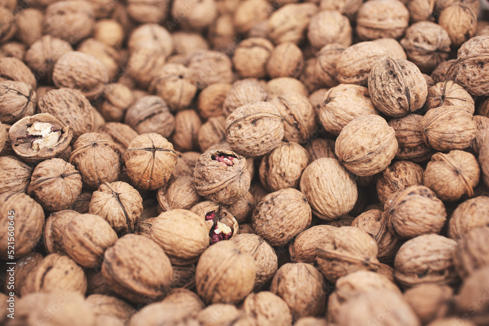 A view of a large pile of walnuts, on display at a local farmers market.