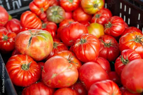 A view of a crate full of heirloom tomatoes, on display at a local farmers market.
