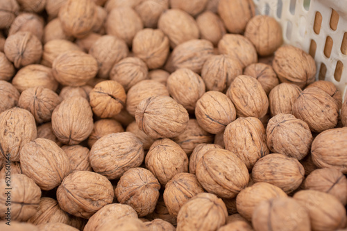 A view of a large pile of walnuts, on display at a local farmers market.