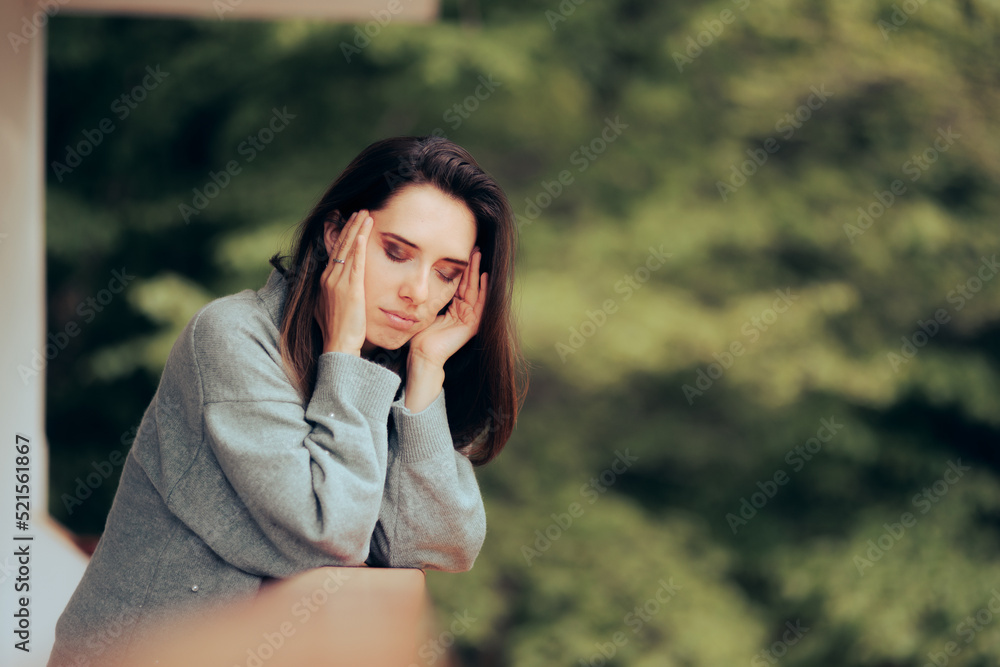 Woman Suffering from a Migraine Standing in the Balcony. Unhappy person feeling unwell having a headache
Woman Suffering from a Migraine Standing in the Balcony. Unhappy person feeling unwell having a headache