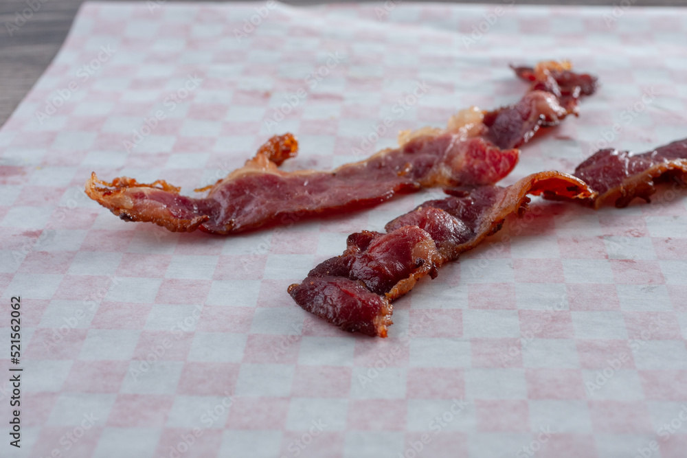 A closeup view of strips of beef bacon.