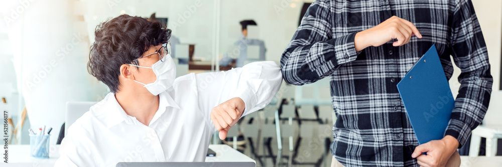 Business people with protective face masks are working in the office keeping a distance during COVID-19 pandemic . social distancing concept. Business people with protective face masks are working in the office keeping a distance during COVID-19 pandemic . social distancing concept.