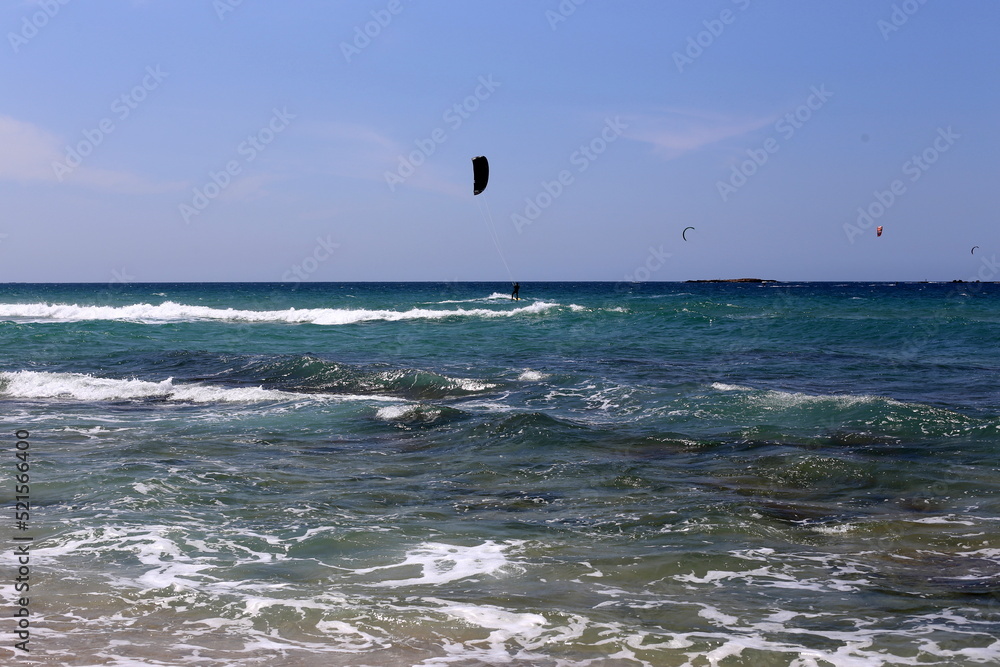 Paragliding in the sky over the Mediterranean Sea.