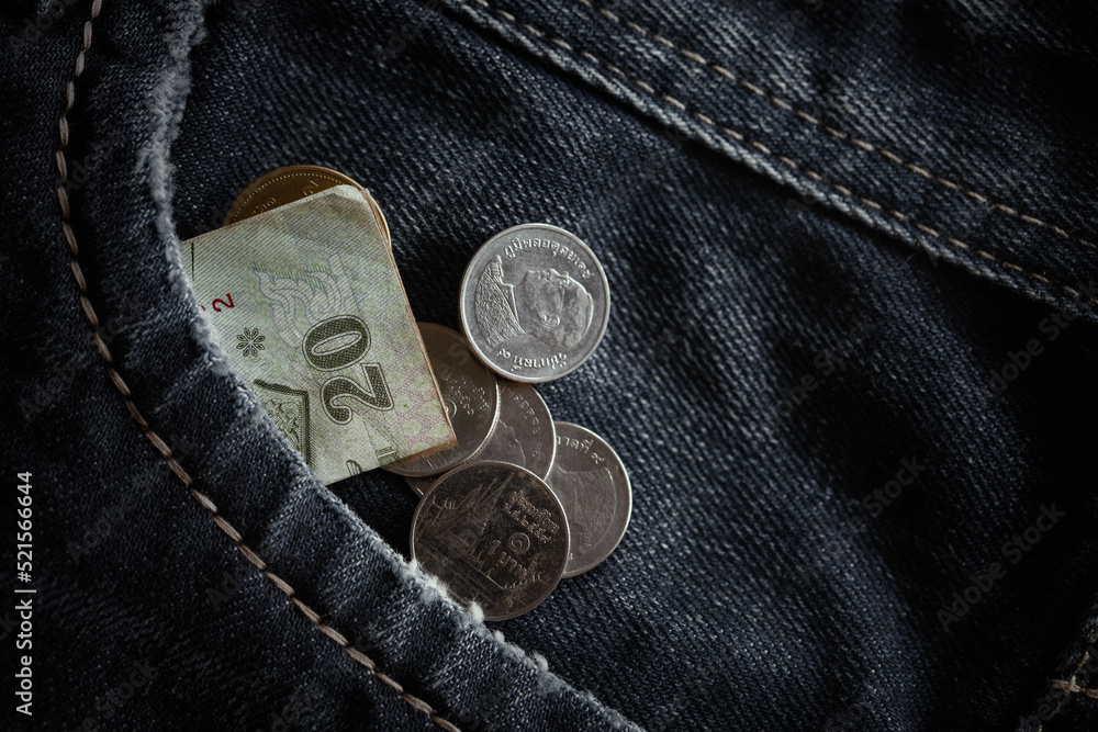 Coins and banknote crumpled in pocket of blue jeans.Concept of Economic recession,unemployment,retirement, global economic crisis Coins and banknote crumpled in pocket of blue jeans.Concept of Economic recession,unemployment,retirement, global economic crisis