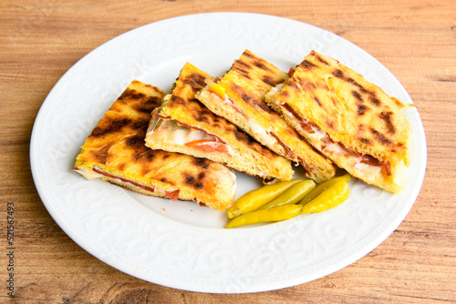 Turkish toast, mixed toast with cheddar cheese, sausage and ham, with fried potatoes (Turkish name; Bazlama Karisik tost)