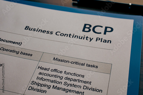 There is dummy documents that created for the photo shoot on the desk about Business Continuity Plan. photo