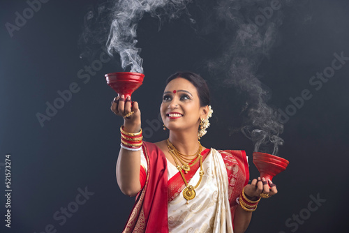 Photography Portrait of Bengali woman holding a dhunuchi