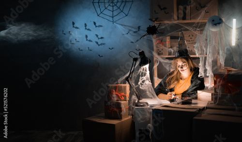 A female dropshipping small business owner using a witch costume. Warehouse worker, salesman. Big sale of goods discounts and promotions in honor of Halloween. Banner.