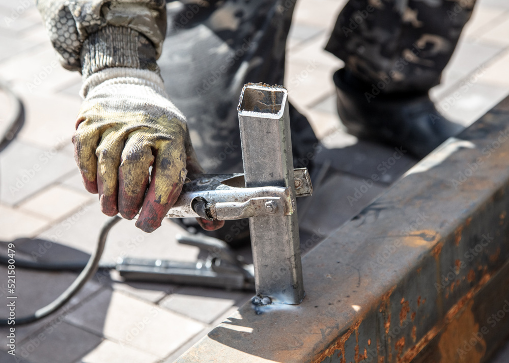 A worker works with metal at a construction site.