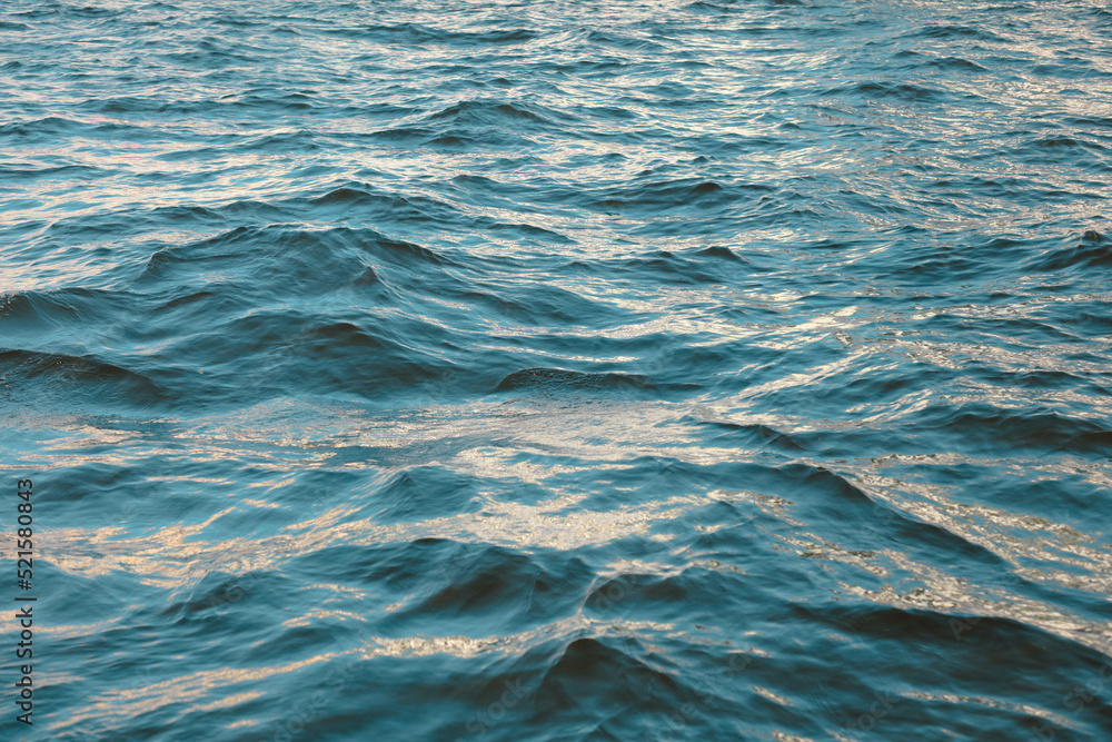 Fototapeta premium Wavy surface of water in a reservoir as an abstract background.