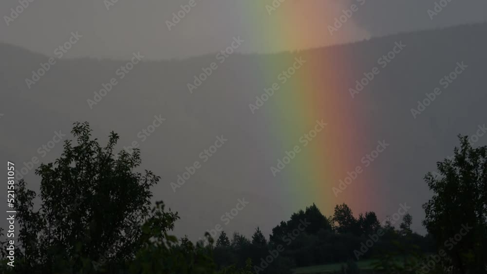 Rainbow in the distance after rain, detail - (4K) Rainbow in the distance after rain, detail - (4K)