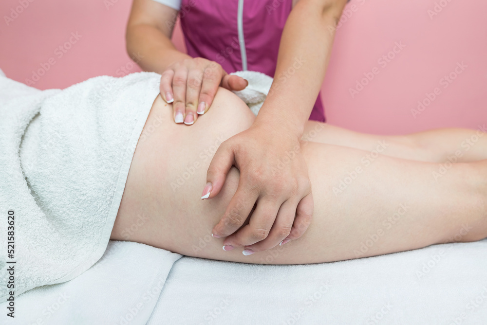 The masseuse makes anti-cellulite massage of the buttocks in the spa. Overweight treatment, body sculpture. The masseuse makes anti-cellulite massage of the buttocks in the spa. Overweight treatment, body sculpture.