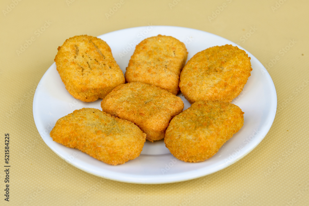 Fried Chicken breast hot crispy strips crunchy chicken tenders isolated on white background.Nuggets isolated on white background on a plate Fried Chicken breast hot crispy strips crunchy chicken tenders isolated on white background.Nuggets isolated on white background on a plate