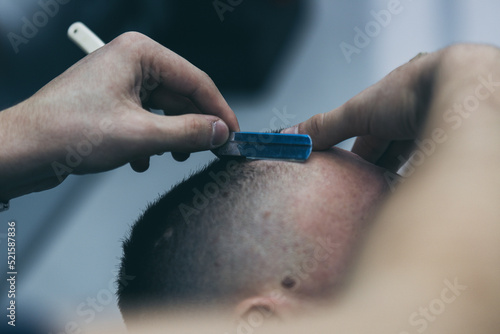 Barbershop haircut styling with dangerous blade
