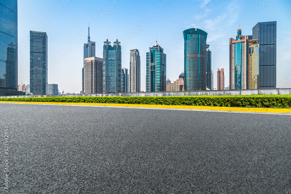 empty asphalt road with city skyline background in china. empty asphalt road with city skyline background in china.