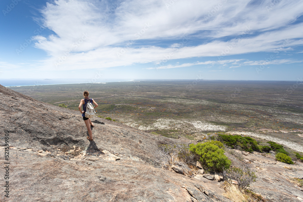 A woman is enjoying beautiful view of Frenchman's peak in Cape Le Grand National Park, Esperance, Western Australia A woman is enjoying beautiful view of Frenchman's peak in Cape Le Grand National Park, Esperance, Western Australia