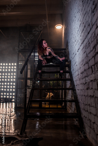 Sexy girl dance on front of spot light wall with smoke