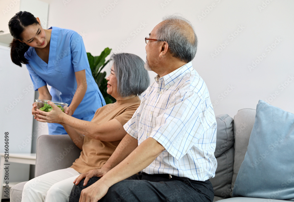 A young nurse is examining the body and asking for symptoms from an elderly patient. A young nurse is examining the body and asking for symptoms from an elderly patient.