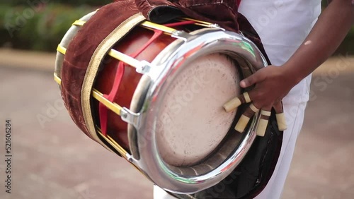 A shot of a musician playing the dholak instrument at a function in New Delhi, India photo