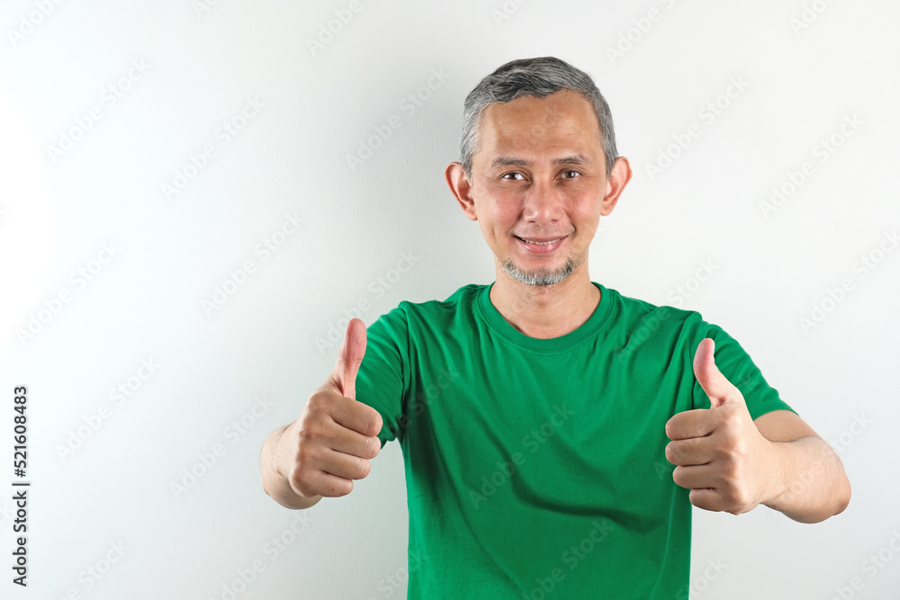 Portrait of Asian man with casual shirt doing positive gesture with hand, thumbs up
Portrait of Asian man with casual shirt doing positive gesture with hand, thumbs up