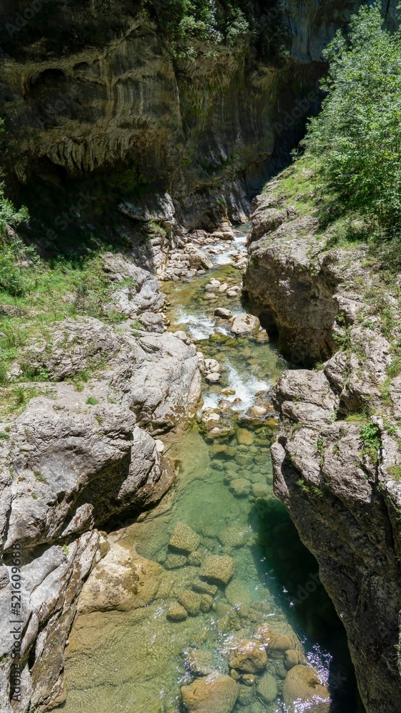 an emerald coloured river winds through a rocky gorge, the Anisclo Canyon, Ordesa National Park, Aragon Spain