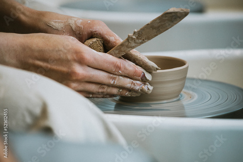work in a pottery workshop. close-up of hands and potter's wheel