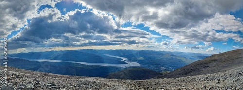 Panoramic view from the mountain top to the landscape under the cloudy sky photo