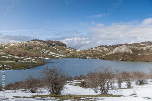 View of the snow-covered mountains landscape and lake under the blue sky photo