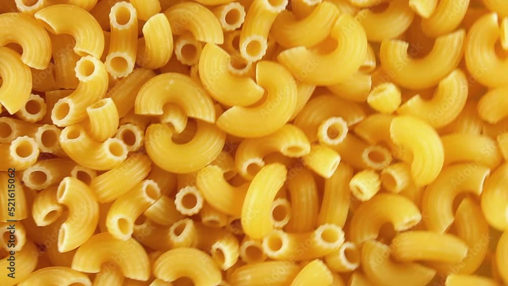 Uncooked Chifferi Rigati Pasta - Top View. Fat and Unhealthy Food. Classic Dry Macaroni, Slowly Rotating Background. Italian Culture and Cuisine. Raw Golden Pasta Texture - Left Angular Rotation Uncooked Chifferi Rigati Pasta - Top View. Fat and Unhealthy Food. Classic Dry Macaroni, Slowly Rotating Background. Italian Culture and Cuisine. Raw Golden Pasta Texture - Left Angular Rotation