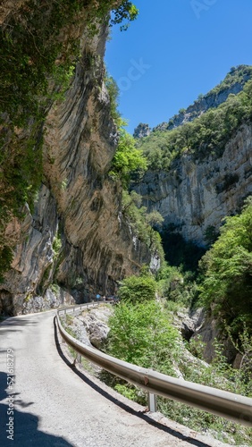 scenic drive road through a karst wall limestone canyon, the Anisclo Canyon, Ordesa National Park, Aragon Spain, blue sky