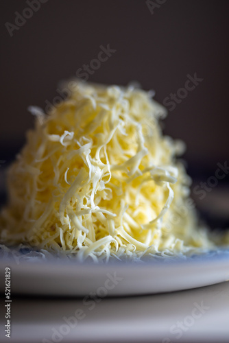 shredded cheese on a plate in a kitchen