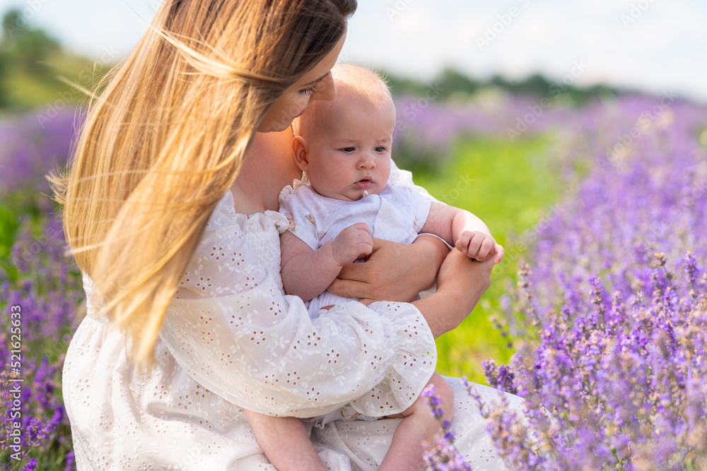 Cute little baby clasped in the arms if its loving mother Cute little baby clasped in the arms if its loving mother