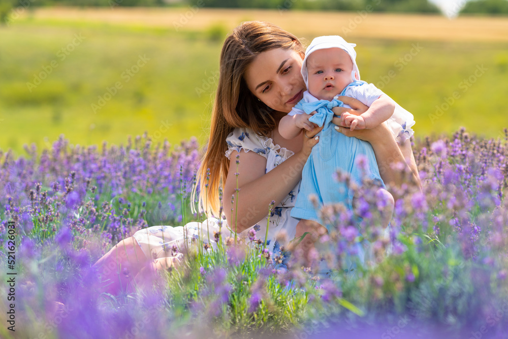 Young mother holding up her baby son to the camera