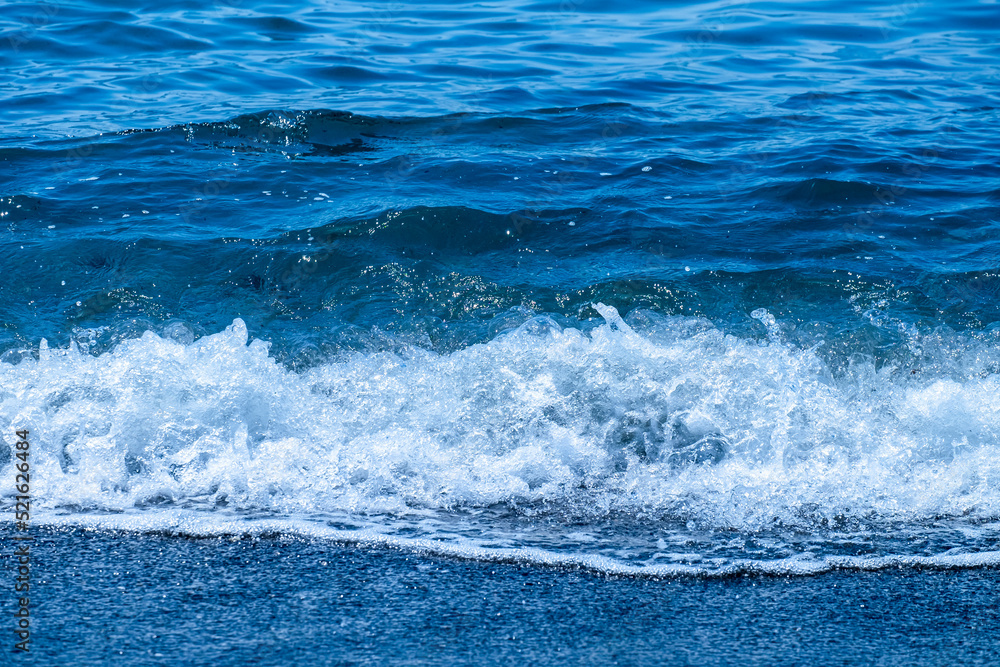 Ocean waves crashing on sandy beach. Sea waves breaking on shore. Ocean waves crashing on sandy beach. Sea waves breaking on shore.