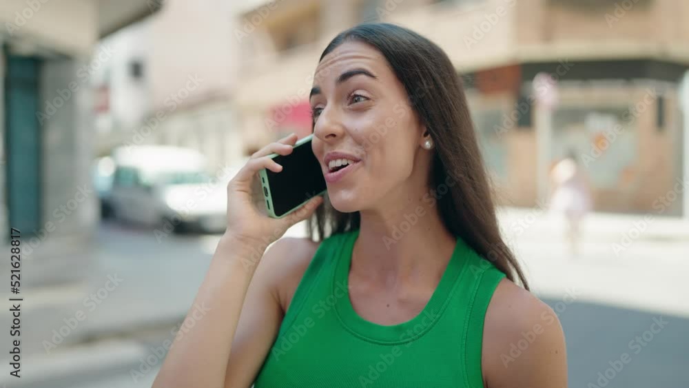 Young beautiful hispanic woman smiling confident talking on the smartphone at street Young beautiful hispanic woman smiling confident talking on the smartphone at street