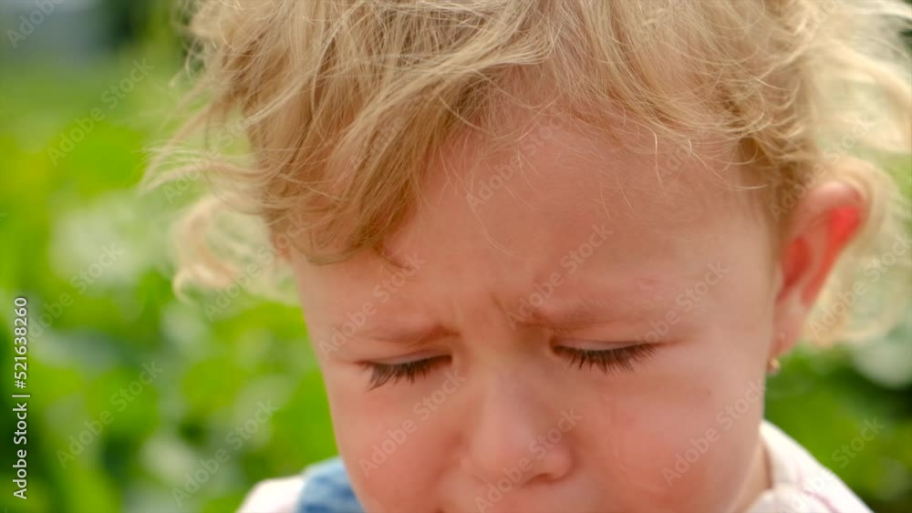 The child is crying in the park. Selective focus. The child is crying in the park. Selective focus.