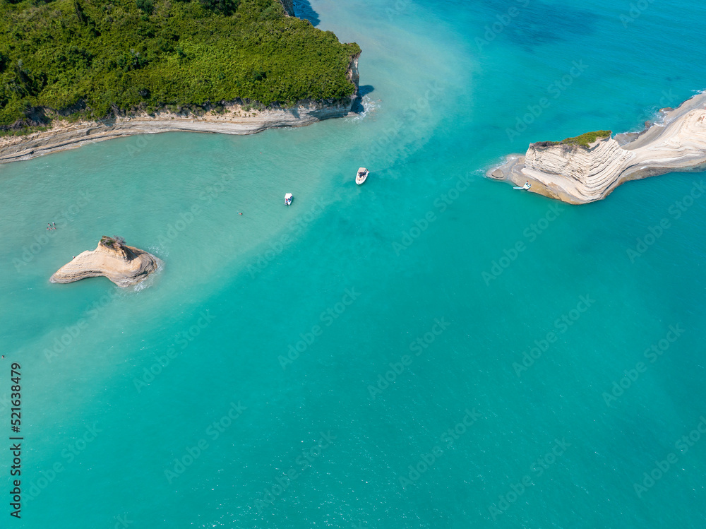 Aerial view of the cliff overlooking the sea near Apotripiti beach and of Mermaid's rock, a promontory on the crystal clear sea. Corfu island, Greece, Ionian sea.
Aerial view of the cliff overlooking the sea near Apotripiti beach and of Mermaid's rock, a promontory on the crystal clear sea. Corfu island, Greece, Ionian sea.