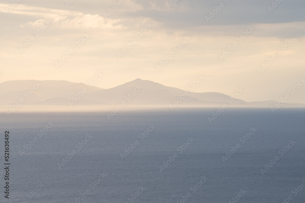 Isle of Harris & Lewis seen from Isle of Skye with beautiful dreamy light over coastal landscape. Scottish Hebrides, UK. Isle of Harris & Lewis seen from Isle of Skye with beautiful dreamy light over coastal landscape. Scottish Hebrides, UK.