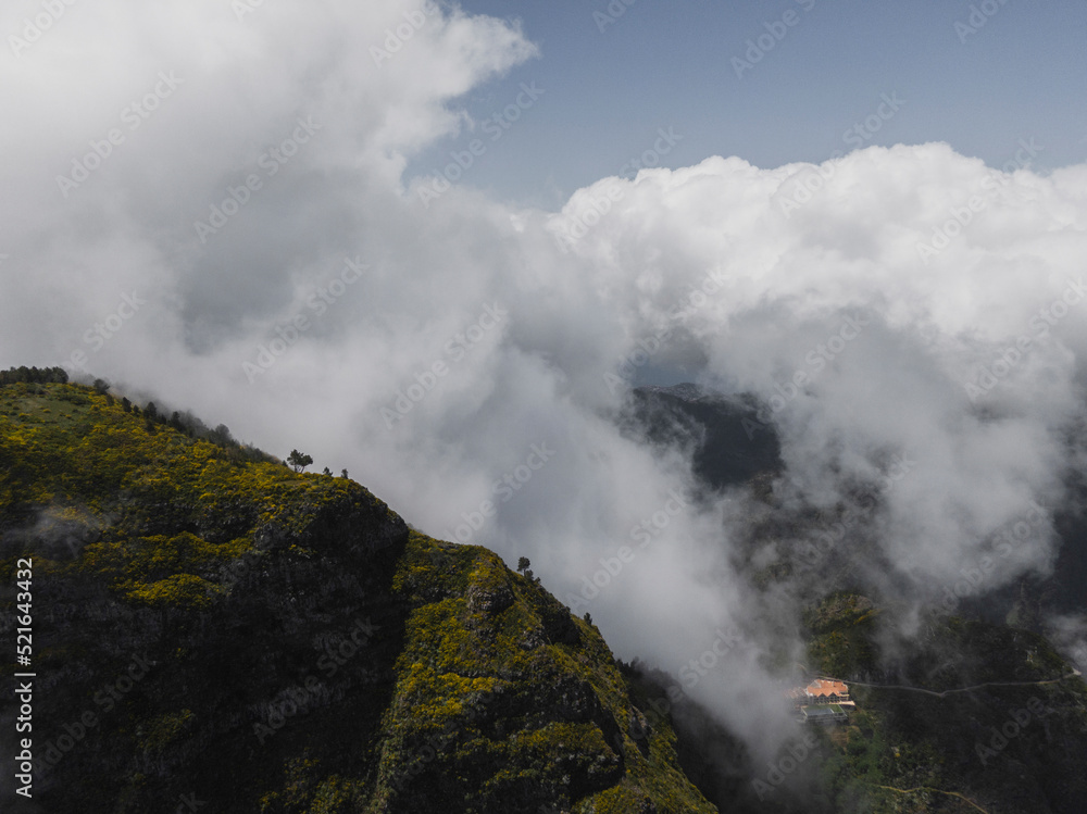Aerial view of a mountain range with low clouds on Madeira Island, Portugal.. Aerial view of a mountain range with low clouds on Madeira Island, Portugal..