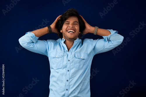 Young handsome man over dark background afraid and shocked with surprise and amazed expression, fear and excited face.