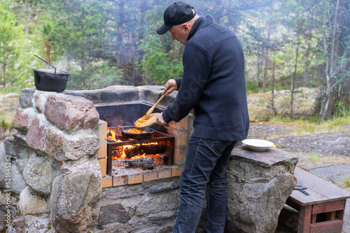 Cooking food on outdoor gri...