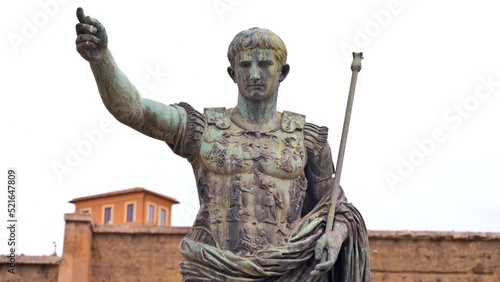 Statue of Julius Augustus Caesar located in the centre of Rome, Italy. Buildings on the background photo