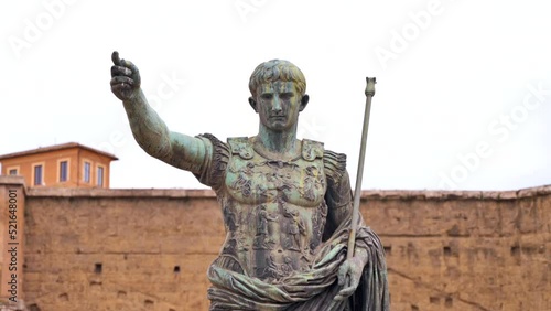 Statue of Julius Augustus Caesar located in the centre of Rome, Italy. Buildings on the background photo