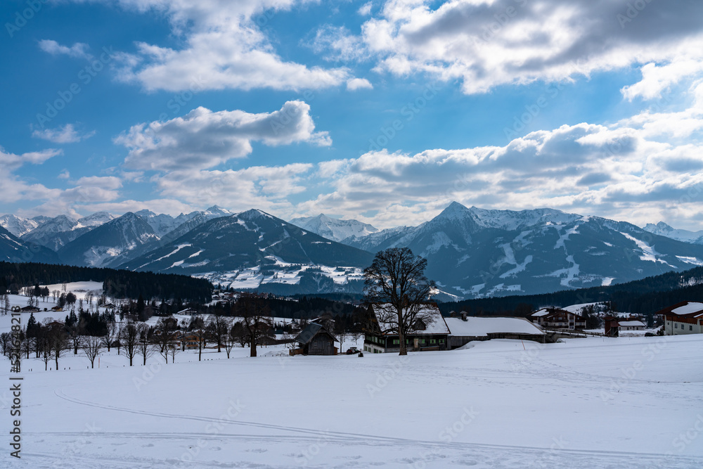 Beautiful panorama view of Ramsau am Dachstein village and Schladming with Planai, Hochwurzen and other peaks of Alps in background with blue sky cloud in winter, Austria