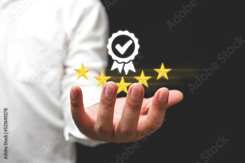 Businessman holding and showing the best quality assurance with golden five stars for guarantee product and ISO service concept, Standard quality control certification assurance guarantee, Guarantee