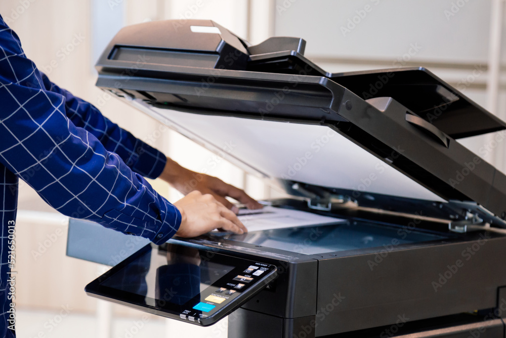 Businessmen press button on the panel for using photocopier or printer for printout and scanning document paper at office. Businessmen press button on the panel for using photocopier or printer for printout and scanning document paper at office.