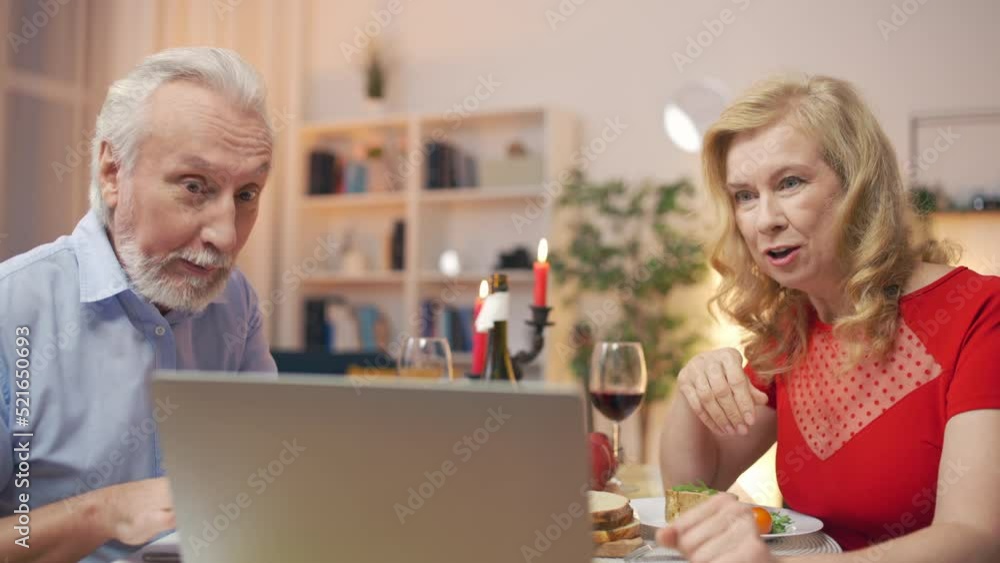 Middle-aged couple talking with kids via video call, together at a distance Middle-aged couple talking with kids via video call, together at a distance